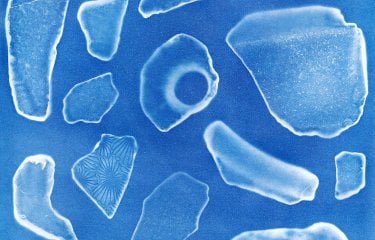 A microscopic view of unidentified fragments on a blue background