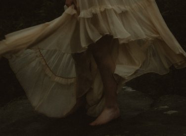 A woman's feet standing on a rock