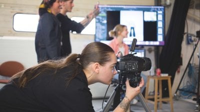 Fashion photography student taking photo in studio