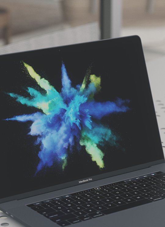 Laptop with a burst of powdered colours.