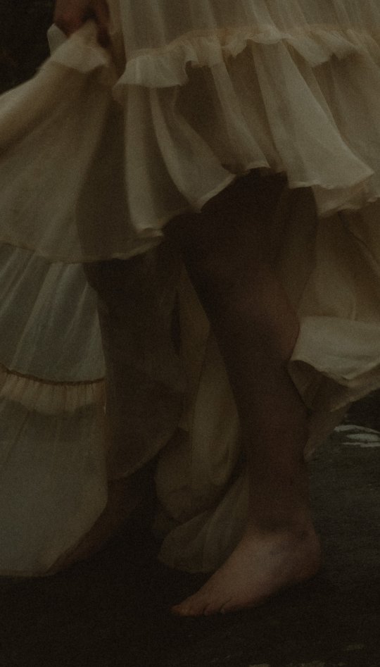 A woman's feet standing on a rock