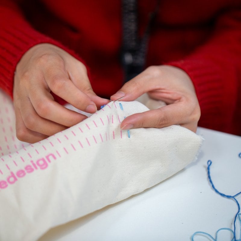 A close-up of someone stitching 