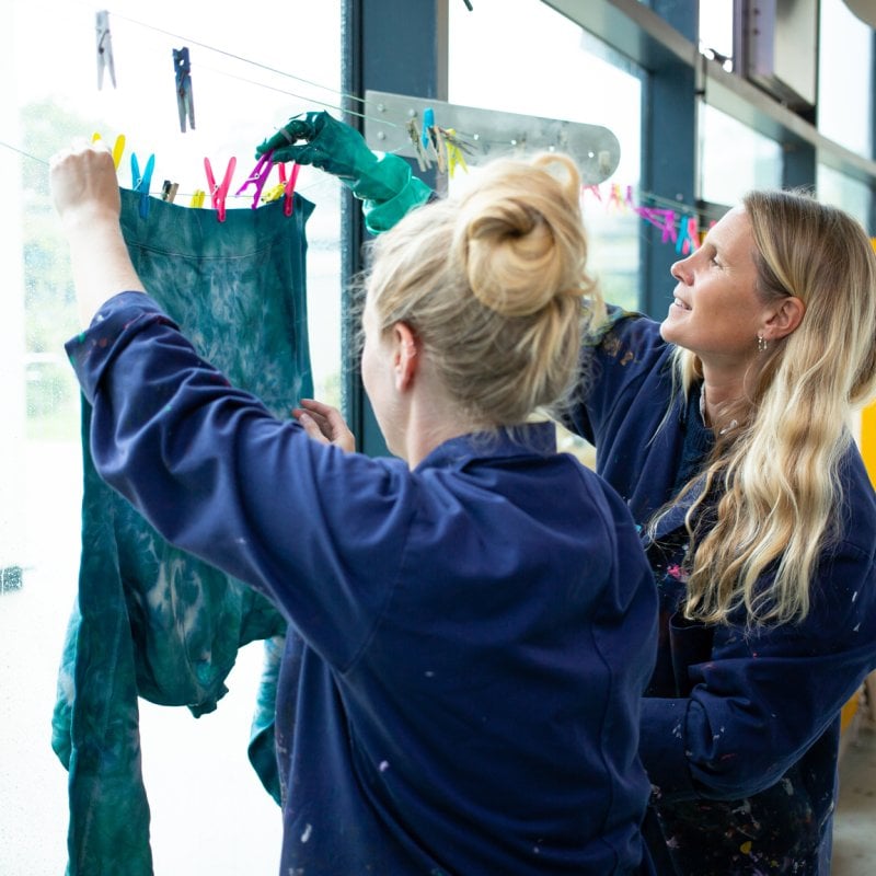 Two people taking part in a dye workshop