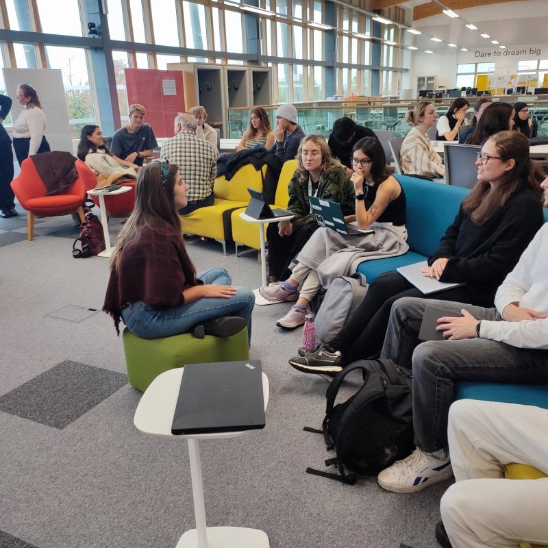 People listening to a speaker at an event