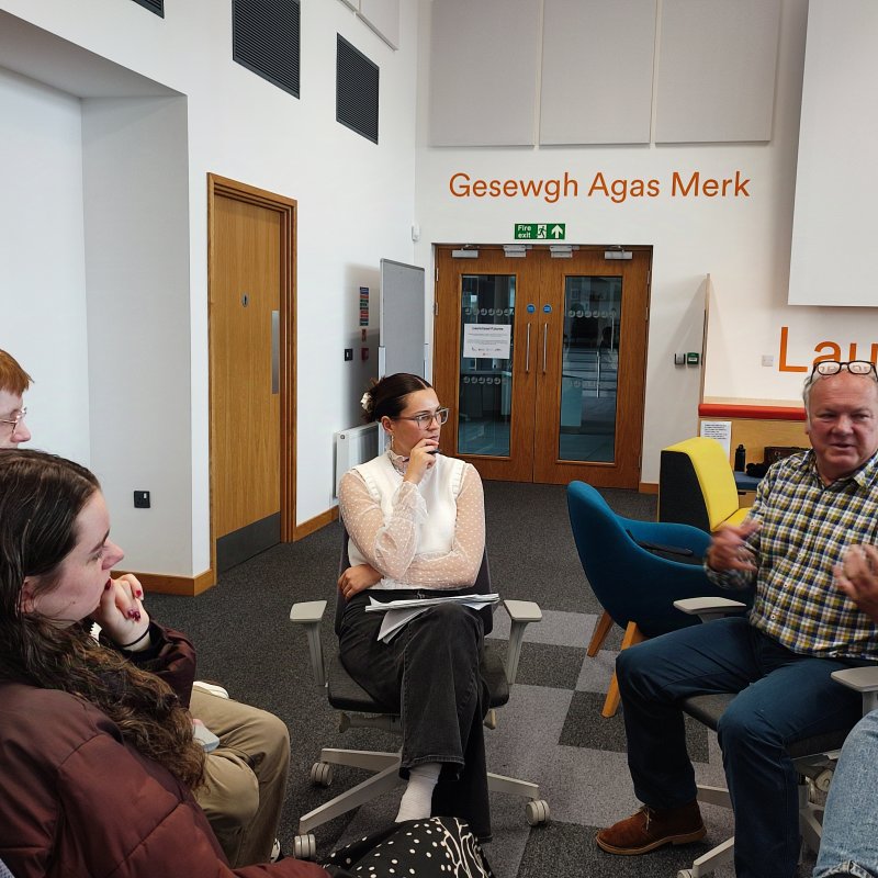 People at a seminar speaking together