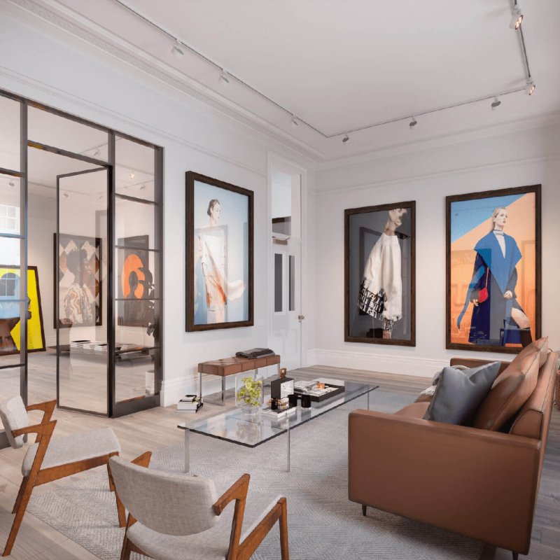 Designed office space with glass coffee table, brown leather couch, mid-century chairs and large fashion photography style artwork