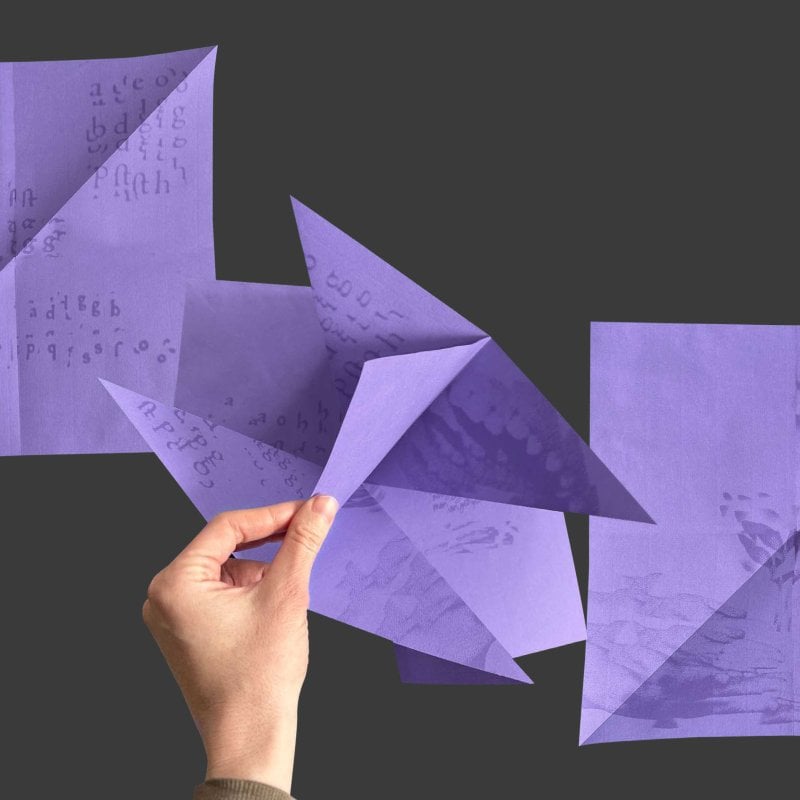 Purple pieces of paper folded into shapes