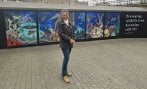 Artist and student Cindy Powell stood next to her mural of wildlife at Paddington station in London