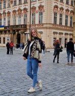 Master's student Inge stood outside a large building 