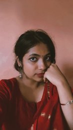 A young woman dressed in a red sari