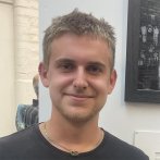 A male Falmouth University student wearing a black tshirt