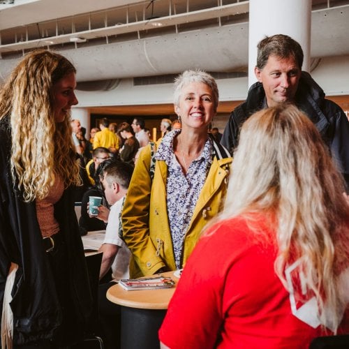 Parents smiling with daughter at an Open Day at Falmouth University