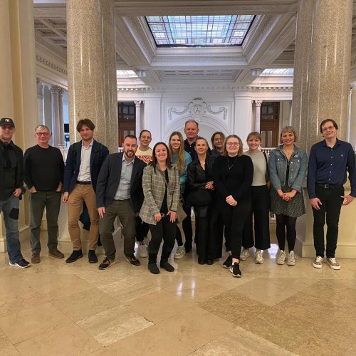 A group of staff and students stood in a museum