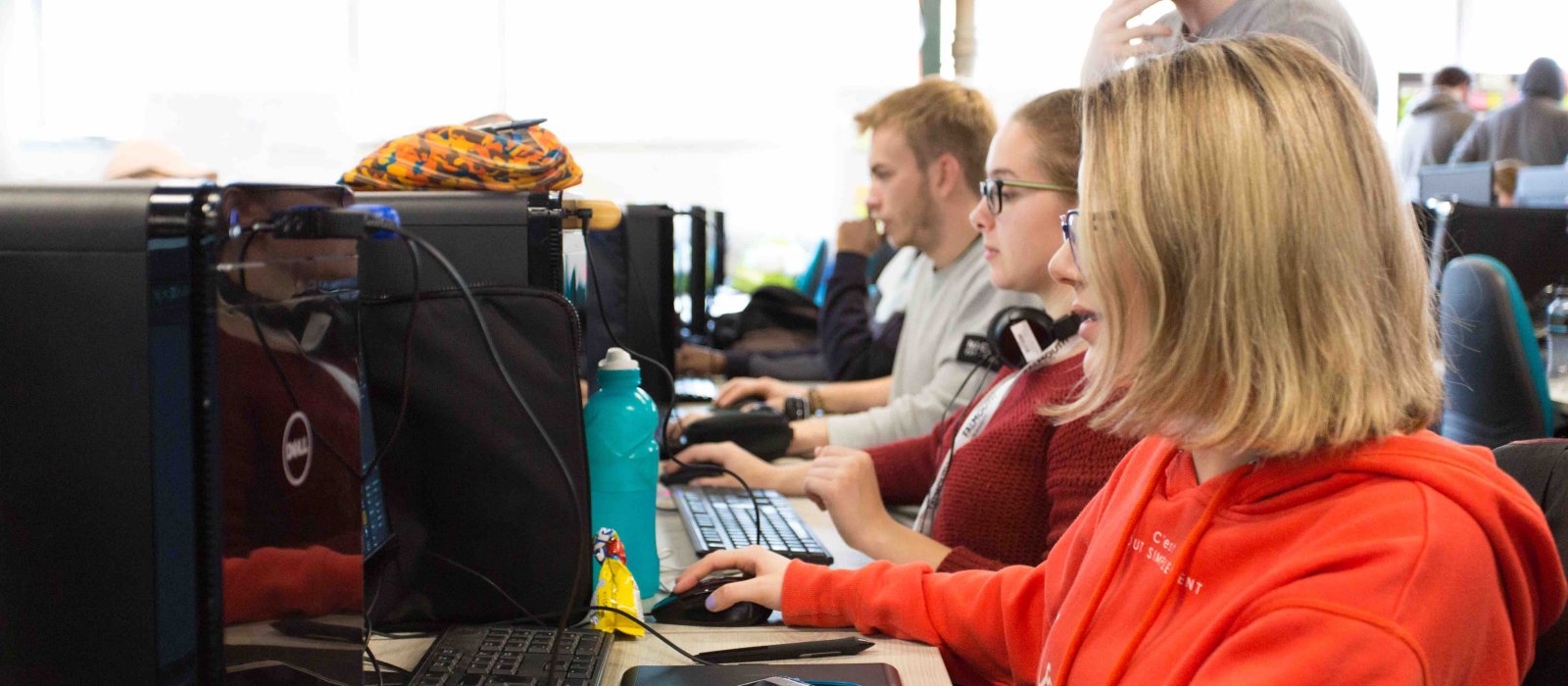 Falmouth University students sitting at computers working together