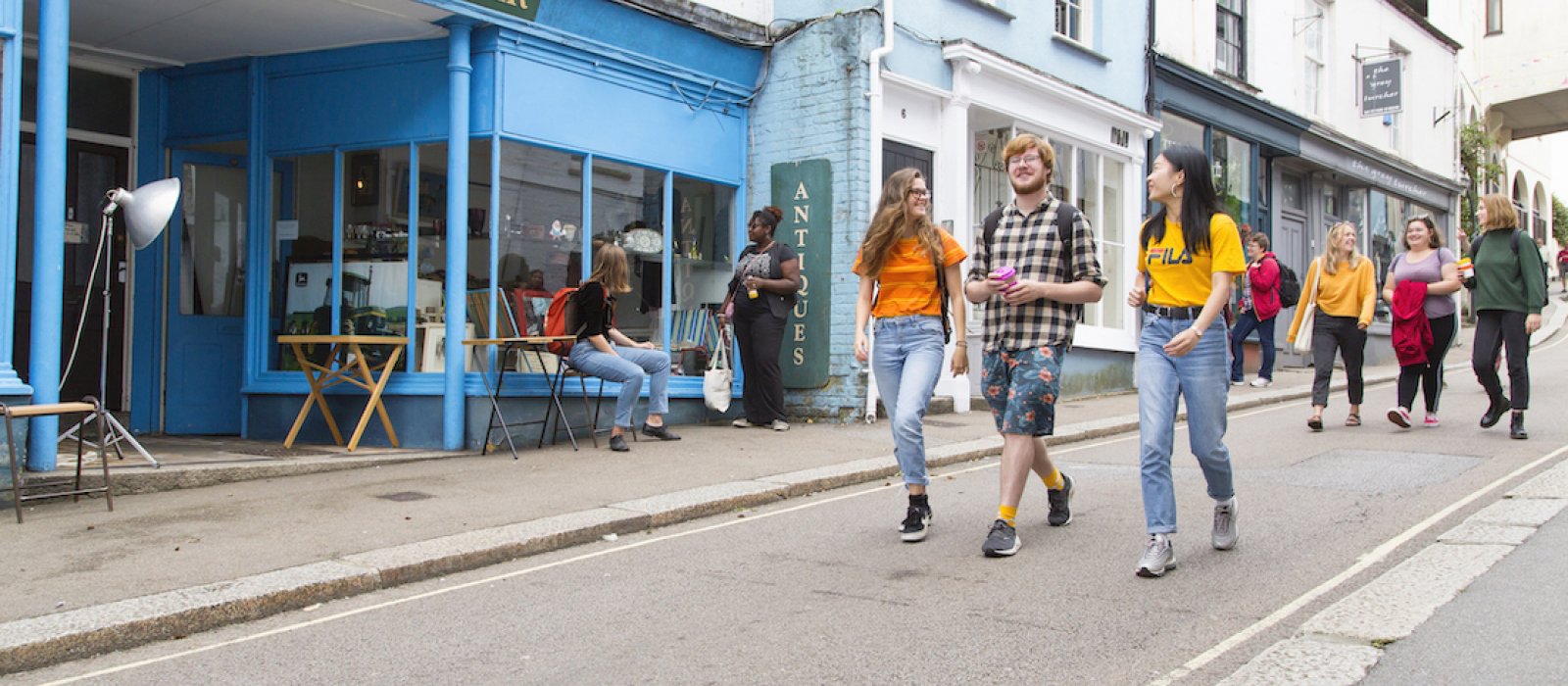 Three students walking down Falmouth high street